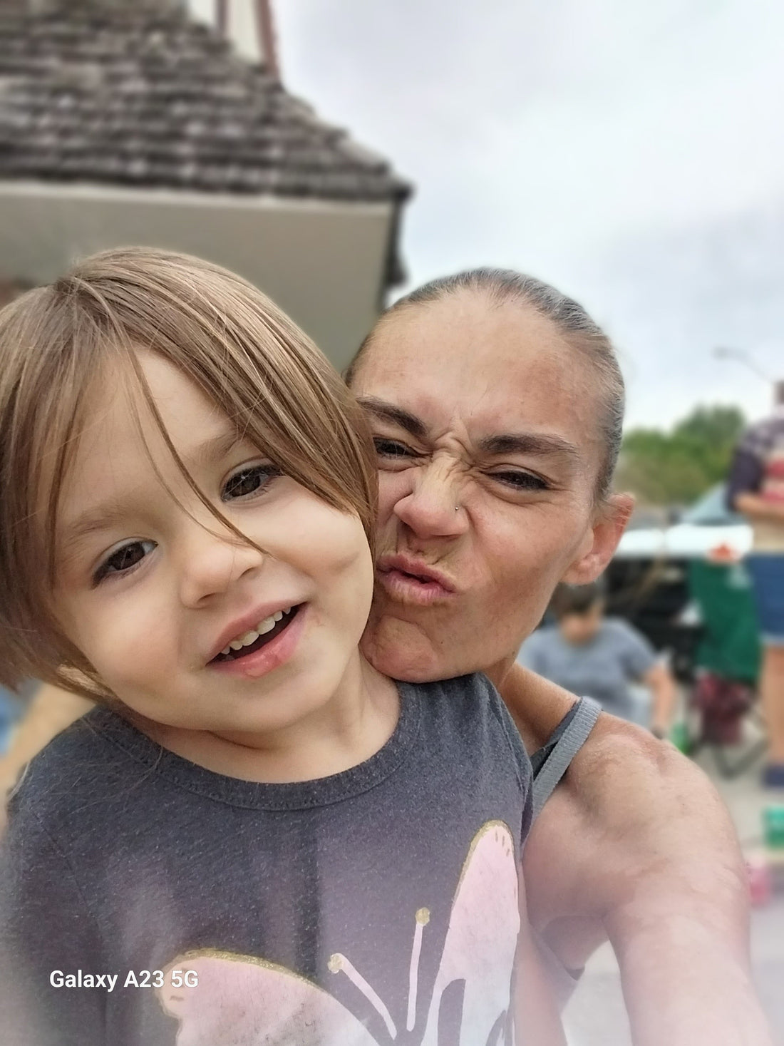 a mother and daughter posing for a funny face selfie